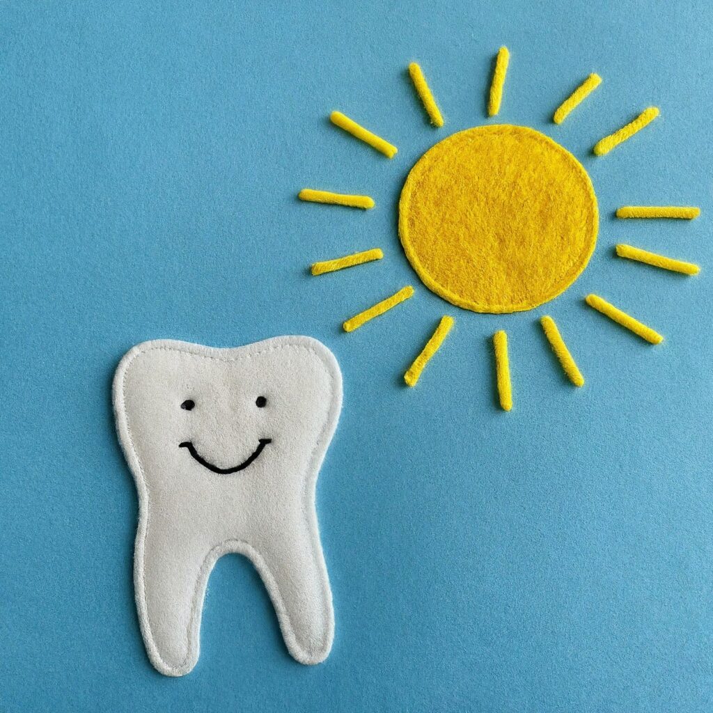 an image showing the sun and a smiling tooth for oral health month
